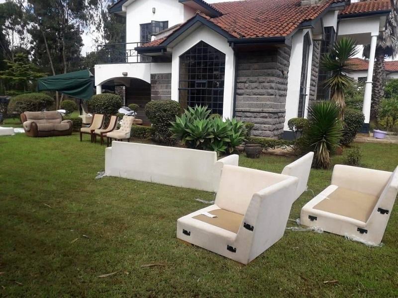Furniture set out for cleaning outside a Nairobi home