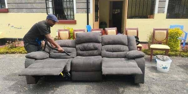 A fabric sofa mid-clean, still showing ground-in dirt